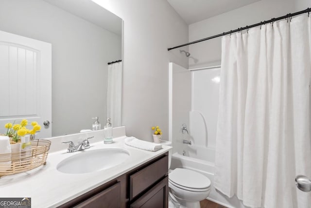 full bathroom with toilet, vanity, and shower / tub combo