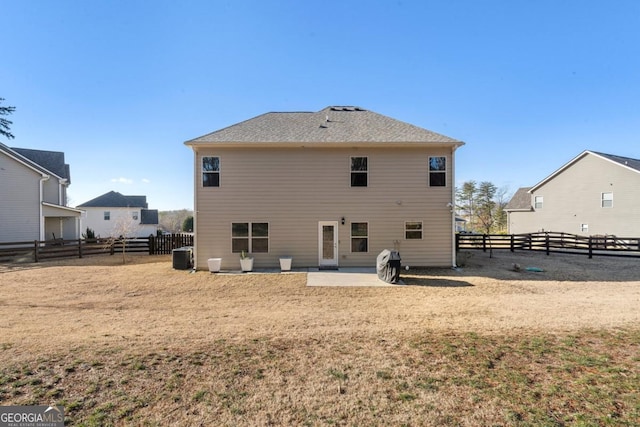 rear view of house with central air condition unit and a patio area