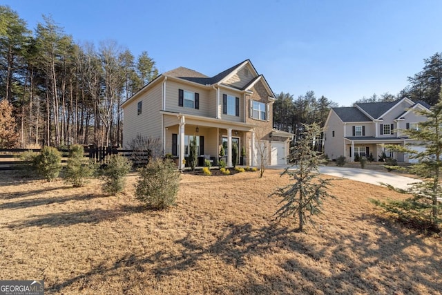 view of front of property with covered porch and a garage