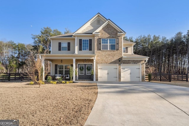 view of front of property featuring a garage, french doors, and covered porch