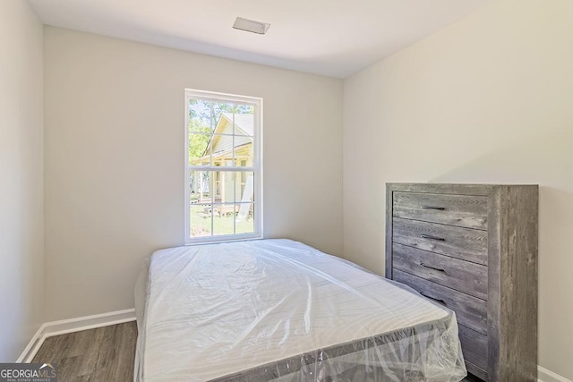 bedroom with wood-type flooring