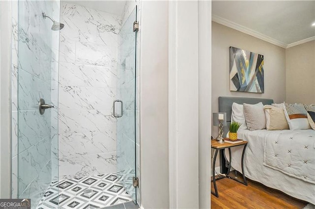 bathroom featuring hardwood / wood-style floors, a shower with door, and crown molding