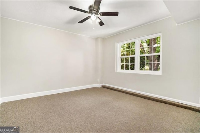 unfurnished room with ceiling fan and carpet