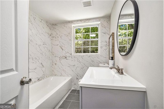 bathroom featuring shower / bathing tub combination, vanity, and tile patterned flooring