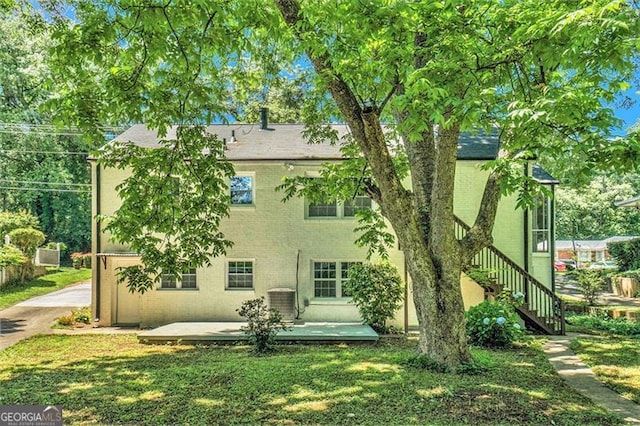 back of house featuring a patio and a yard