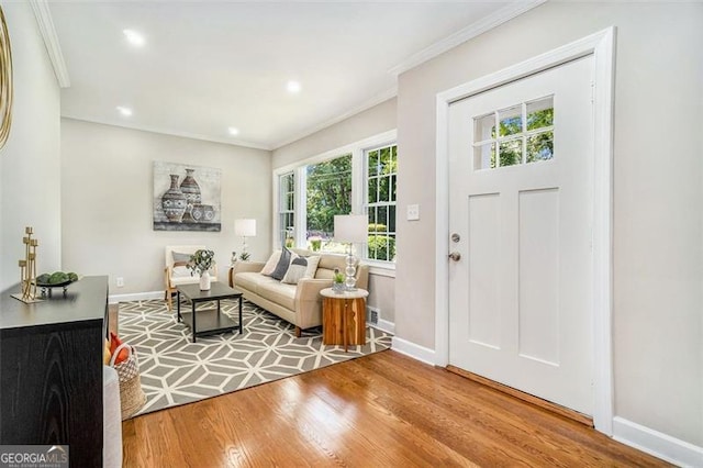 entrance foyer with wood-type flooring and crown molding