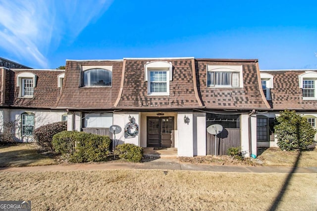 113 Rue Fontaine Unit 113, Lithonia, GA 30038 - view of front of home featuring mansard roof and roof with shingles