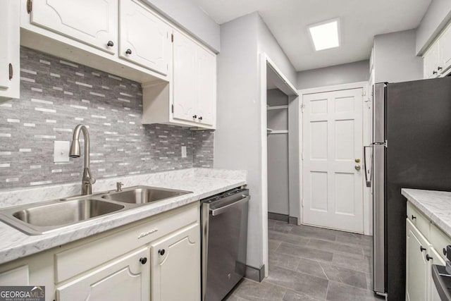 113 Rue Fontaine Unit 113, Lithonia, GA 30038 - kitchen with appliances with stainless steel finishes, a sink, backsplash, and light countertops