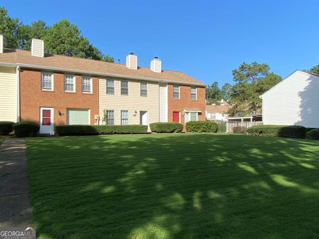 back of house with a yard