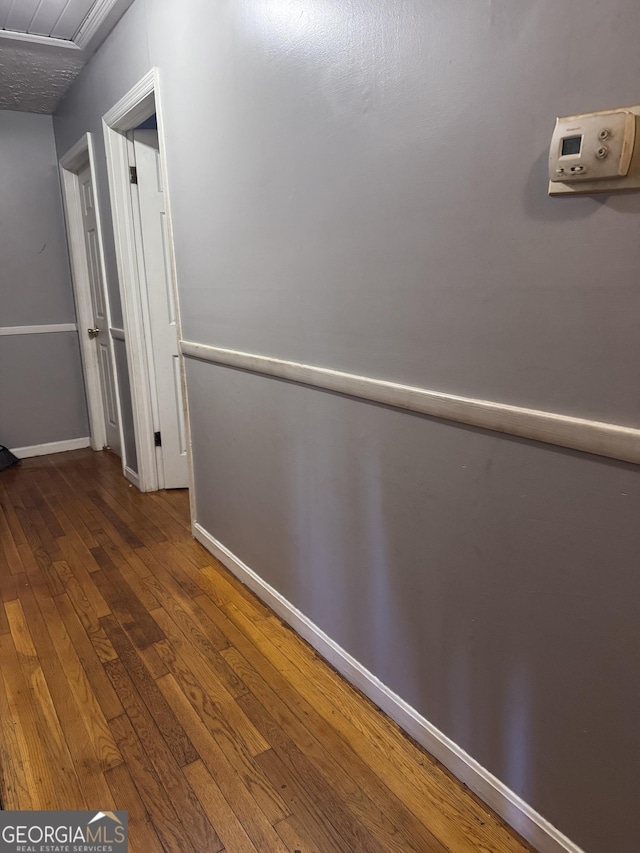 hallway with wood-type flooring