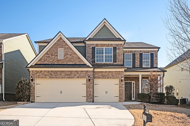 craftsman-style home with cooling unit and a garage