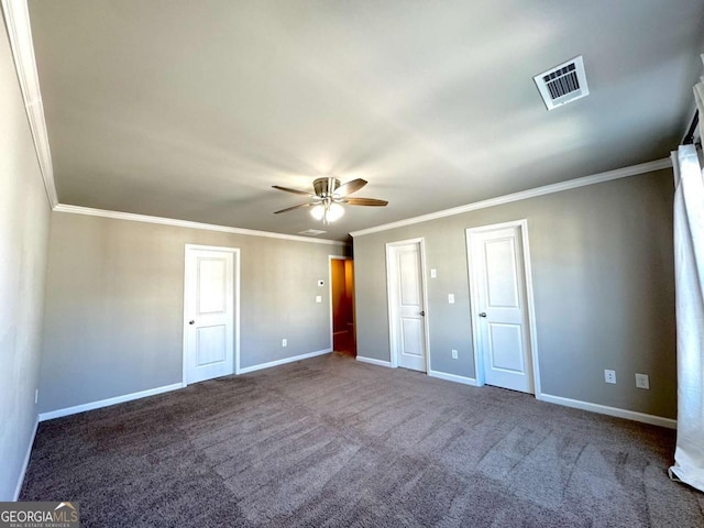 unfurnished bedroom with ceiling fan, carpet, crown molding, and multiple closets