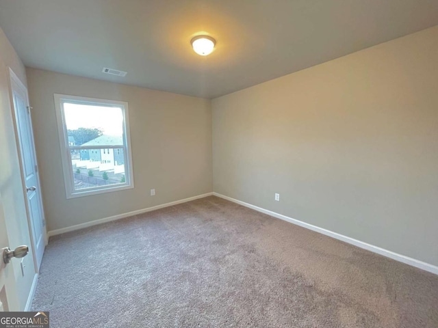 unfurnished room with light carpet