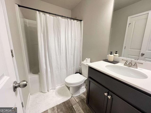 full bathroom featuring toilet, shower / bath combo, wood-type flooring, and vanity