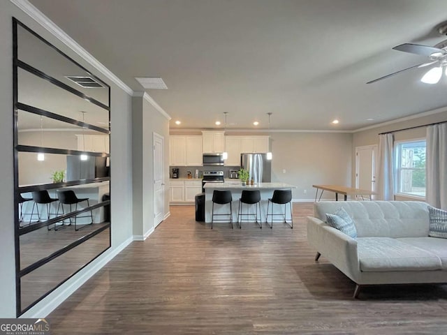 living room featuring ceiling fan, dark wood-type flooring, and crown molding