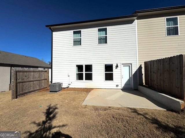 rear view of property featuring central AC and a patio