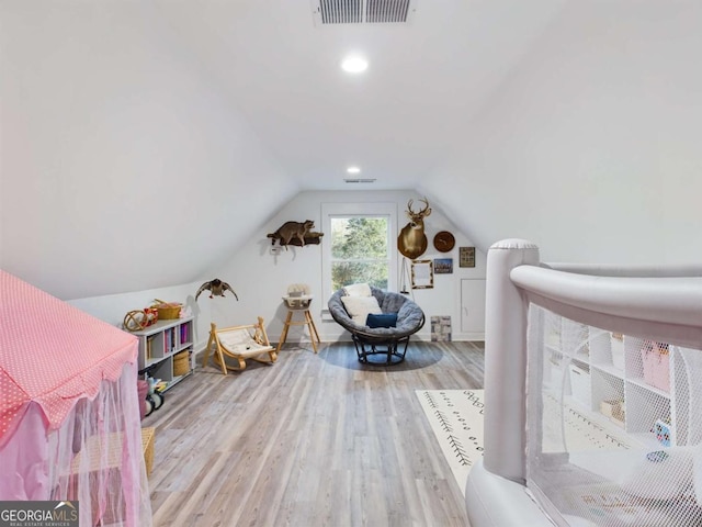 game room featuring light hardwood / wood-style flooring and vaulted ceiling