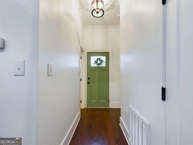 doorway to outside with dark wood-type flooring and ornamental molding