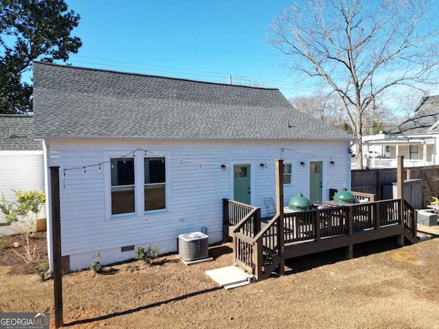 back of property with central AC unit and a deck