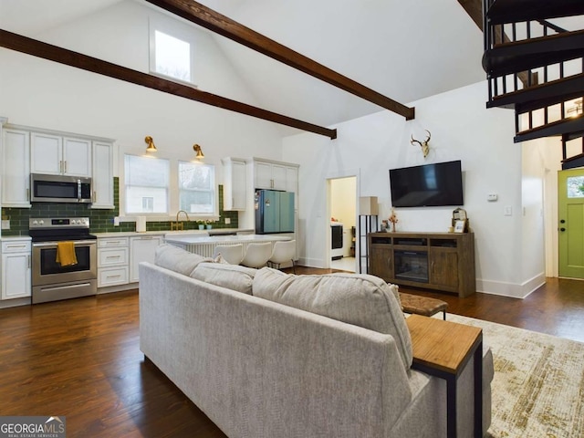 living room featuring high vaulted ceiling, sink, dark hardwood / wood-style flooring, and beamed ceiling