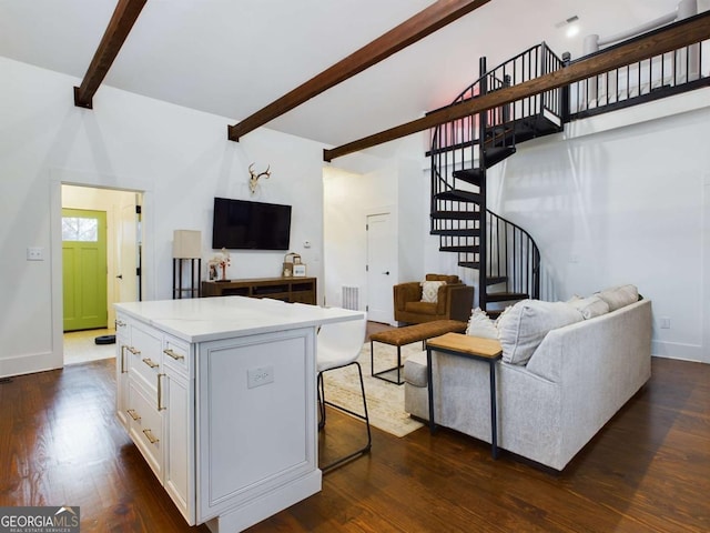 living room featuring dark hardwood / wood-style flooring and beamed ceiling