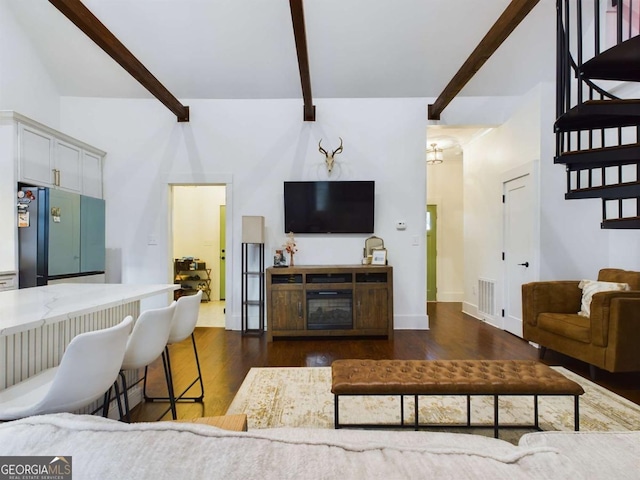 living room featuring dark hardwood / wood-style floors and beamed ceiling