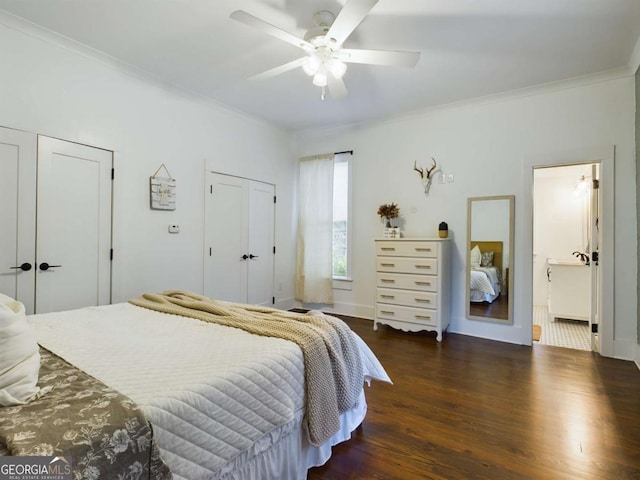 bedroom with ceiling fan, crown molding, dark hardwood / wood-style floors, and multiple closets