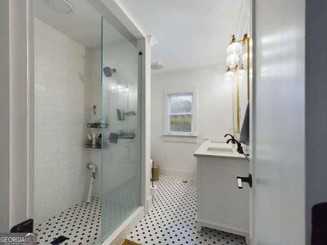 bathroom with vanity, ornamental molding, and an enclosed shower