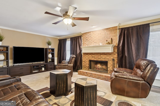 living room featuring a fireplace, ceiling fan, crown molding, and light colored carpet