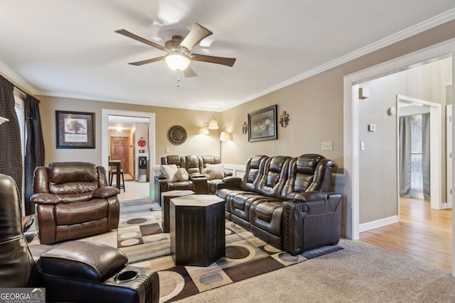 carpeted living room featuring ceiling fan and crown molding