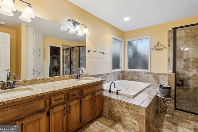 bathroom featuring independent shower and bath and vanity