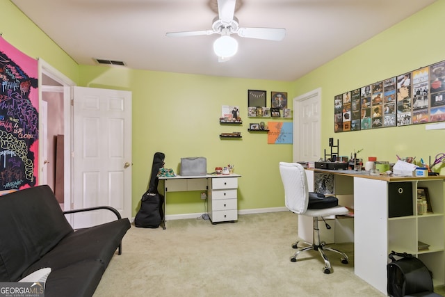 carpeted office space with ceiling fan