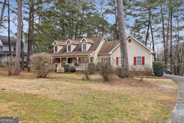 cape cod-style house with a front lawn and a porch