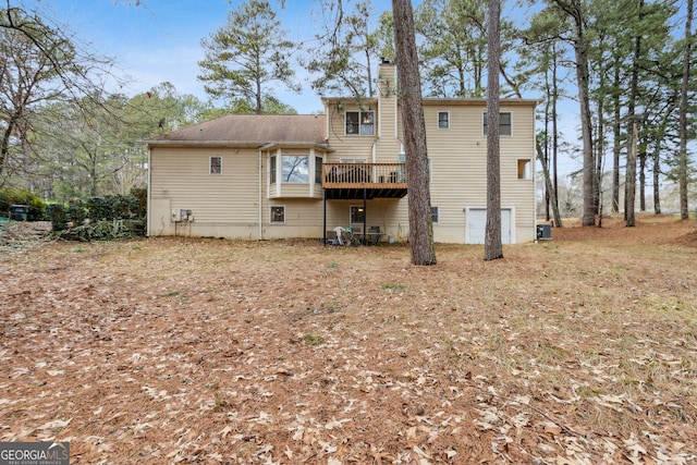 back of house featuring central AC unit and a deck