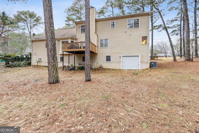 back of house with a deck, a garage, and central AC