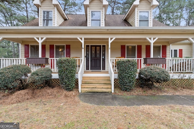 new england style home featuring covered porch