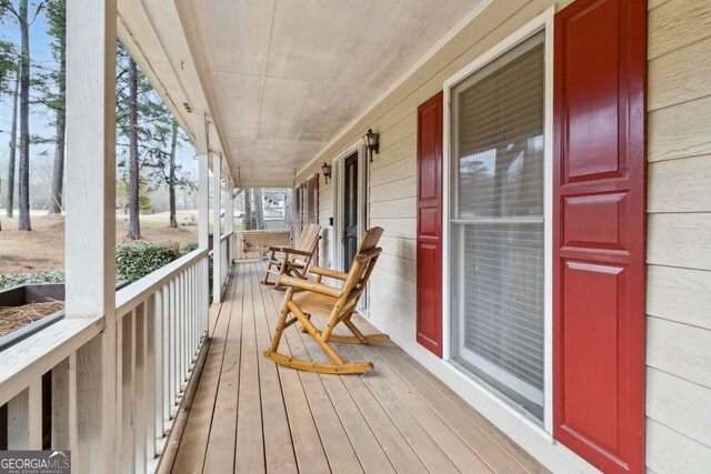 wooden terrace featuring a porch