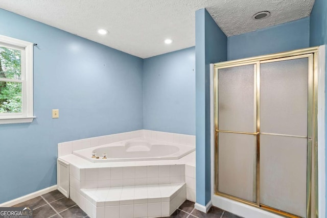 bathroom with a textured ceiling, shower with separate bathtub, and tile patterned floors