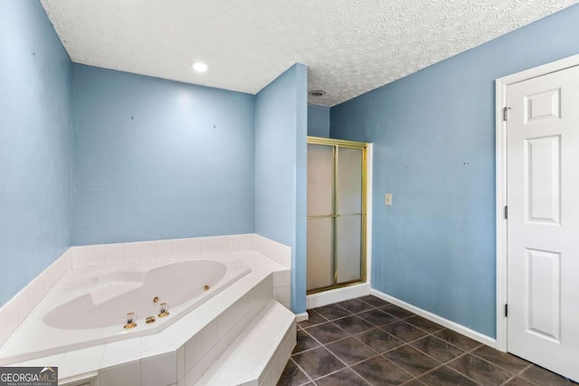 bathroom with separate shower and tub, tile patterned floors, and a textured ceiling