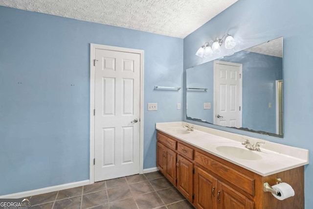 bathroom featuring a textured ceiling and vanity