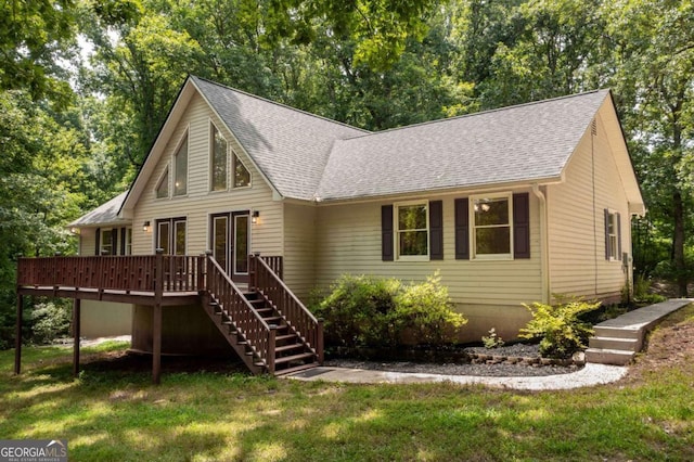 view of front of house featuring a front yard and a deck