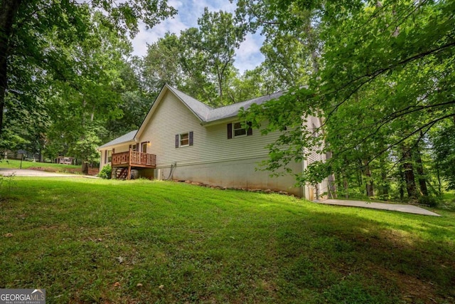 view of property exterior featuring a deck and a yard