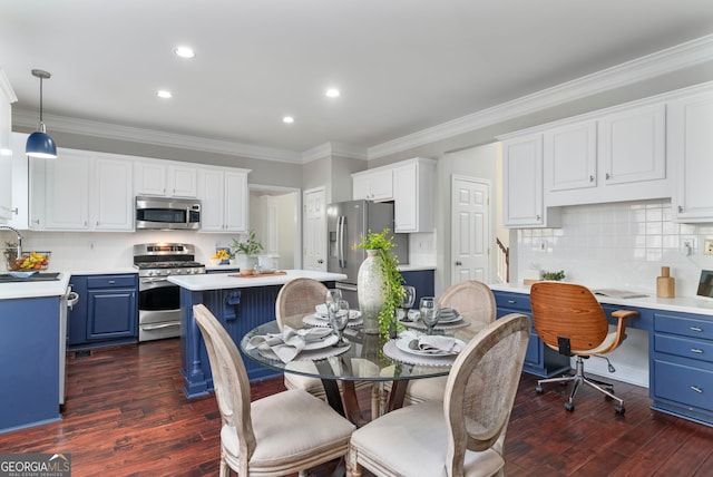 kitchen with a kitchen island, white cabinetry, appliances with stainless steel finishes, and blue cabinetry