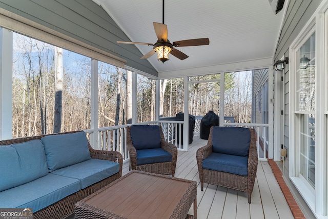 sunroom featuring lofted ceiling and ceiling fan