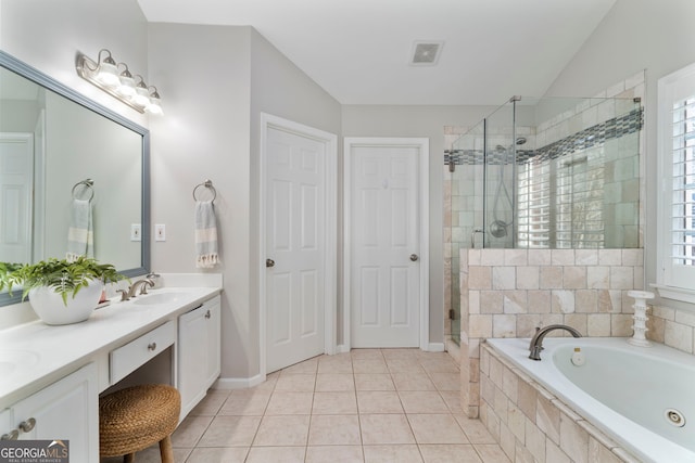 bathroom with a healthy amount of sunlight, tile patterned floors, independent shower and bath, and vanity