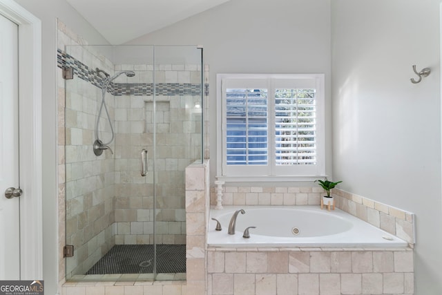 bathroom featuring lofted ceiling and plus walk in shower