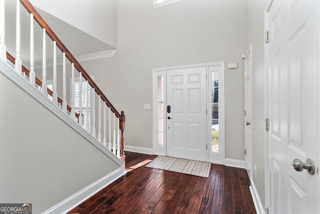 foyer entrance featuring a high ceiling and wood-type flooring