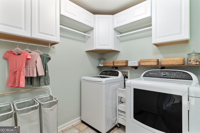 laundry room featuring cabinets and separate washer and dryer