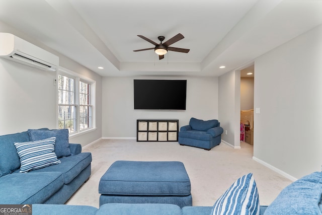 carpeted living room with a wall mounted air conditioner, a raised ceiling, and ceiling fan