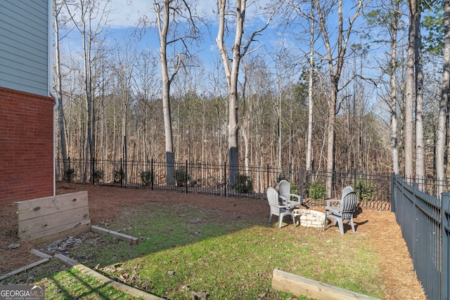 view of yard with an outdoor fire pit